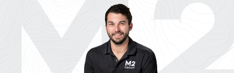 Scott Humphreys, project manager at M2 Group, smiling in a black company polo shirt.